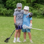 two boys in lacrosse gear
